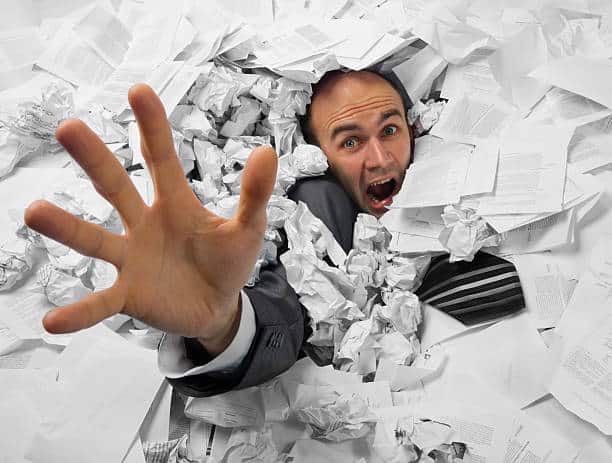 bookkeeper buried in paperwork